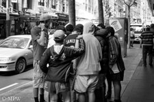 Group of young guys checking out the latest in Queen St, Auckland
